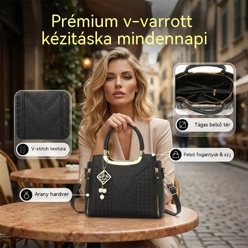 Női válltáska V-alakú varrással, arany szerelékekkel, több rekesszel és felső fogantyúval.